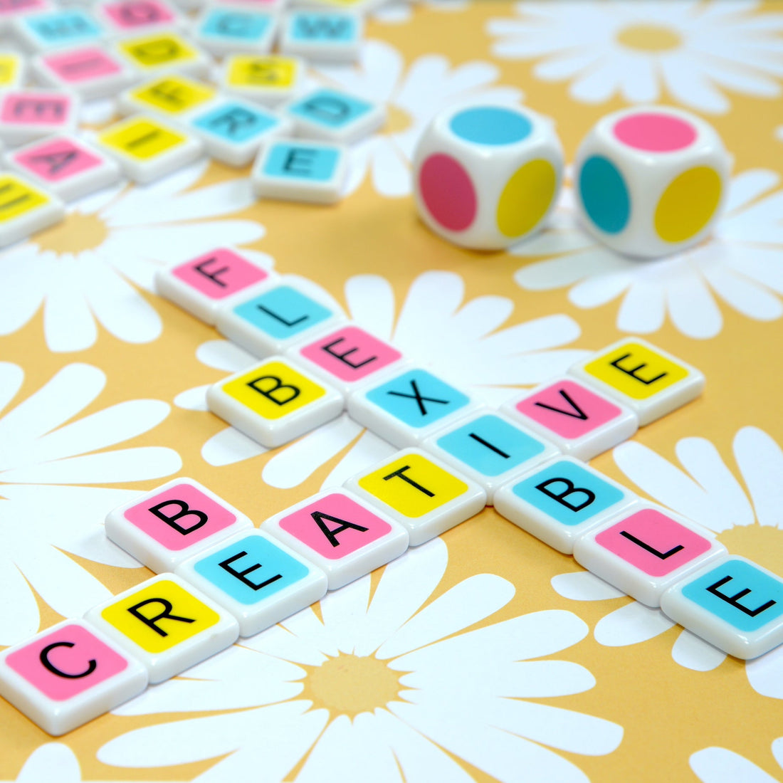 With a little creativity Candygrams “the colorful crossword game” can have many challenging variations. large colorful dice along with a colorful letter tiles spelling ‘be creative be flexible’ on a yellow and white flower background