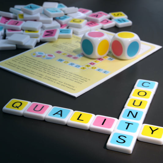 With quality components, Candygrams board game will hold up to generations of play. large colorful dice along with a colorful letter tiles spelling ‘quality counts’ on a dark background