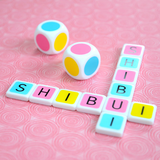 Shibui is a Japanese aesthetic concept associated with an approach that is understated, clean, and refined. ‘shibui’ crossword made with colorful letter tiles on a pink background